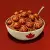 AI illustration featuring a maple leaf emblazened bowl of spaghetti with meatballs imprinted with the registered trademark symbol on a red background